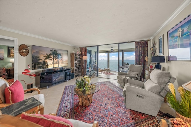 living room featuring a textured ceiling, floor to ceiling windows, ornamental molding, and tile patterned floors