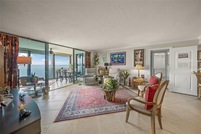 tiled living room with crown molding, floor to ceiling windows, a water view, and a textured ceiling
