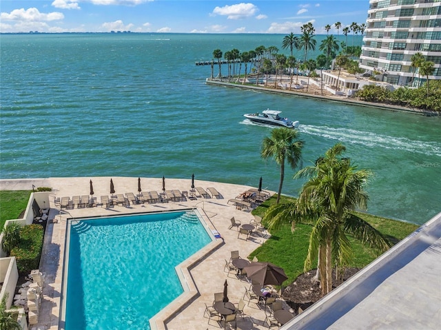 community pool featuring a water view and a patio area