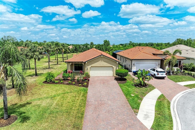mediterranean / spanish-style house with a tile roof, decorative driveway, an attached garage, a front yard, and stucco siding