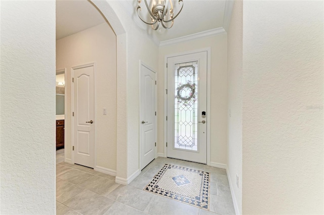 entryway with a textured wall, arched walkways, light tile patterned floors, and an inviting chandelier
