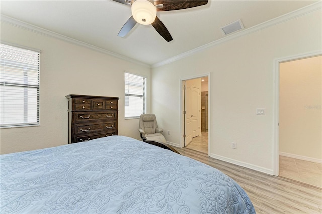 bedroom with a ceiling fan, crown molding, light wood finished floors, baseboards, and visible vents