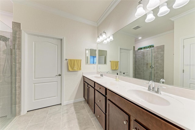 bathroom featuring a notable chandelier, crown molding, a sink, and tiled shower