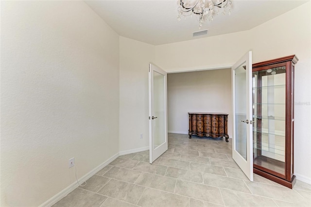 unfurnished bedroom with visible vents, light tile patterned floors, french doors, baseboards, and a notable chandelier