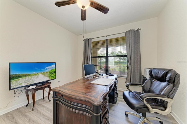 office area with light wood finished floors, baseboards, and ceiling fan