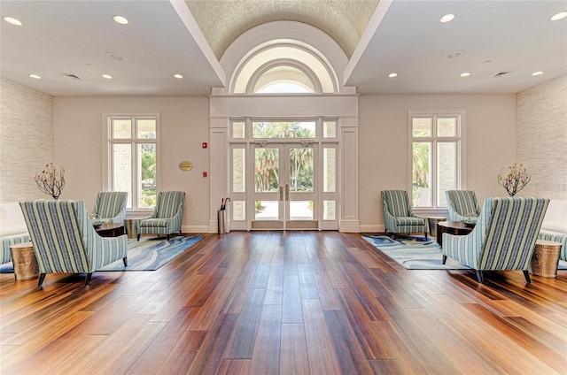 living area featuring baseboards, wood finished floors, and plenty of natural light