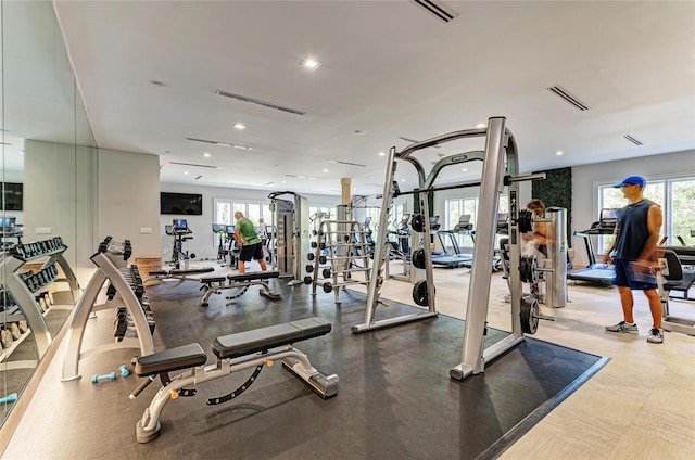 exercise room with visible vents and recessed lighting
