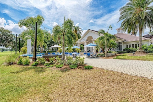 view of property's community with a patio area and a yard