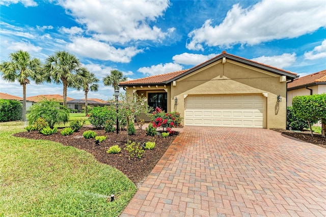 view of front of house featuring stucco siding, an attached garage, decorative driveway, and a front yard