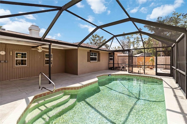 view of pool with a fenced in pool, a patio, a ceiling fan, glass enclosure, and fence