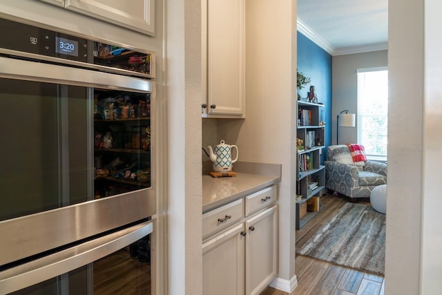 11702 Tetrafin Dr, Riverview, FL 33579 - bar featuring ornamental molding, wood finished floors, and double oven