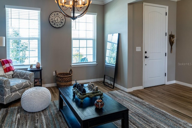 11702 Tetrafin Dr, Riverview, FL 33579 - living area with wood finished floors, a chandelier, baseboards, and crown molding