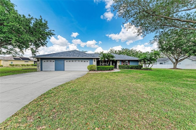 ranch-style home featuring concrete driveway, an attached garage, fence, and a front lawn