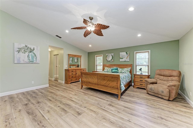 bedroom with vaulted ceiling, multiple windows, light wood finished floors, and visible vents