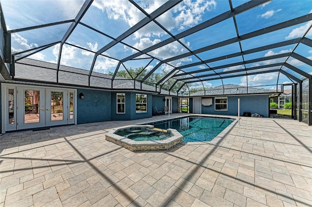 view of pool with a lanai, a patio area, a pool with connected hot tub, and french doors