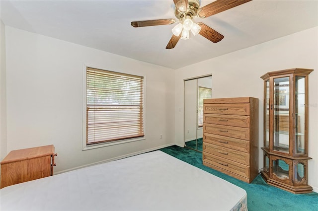 bedroom with a ceiling fan, multiple windows, and dark colored carpet