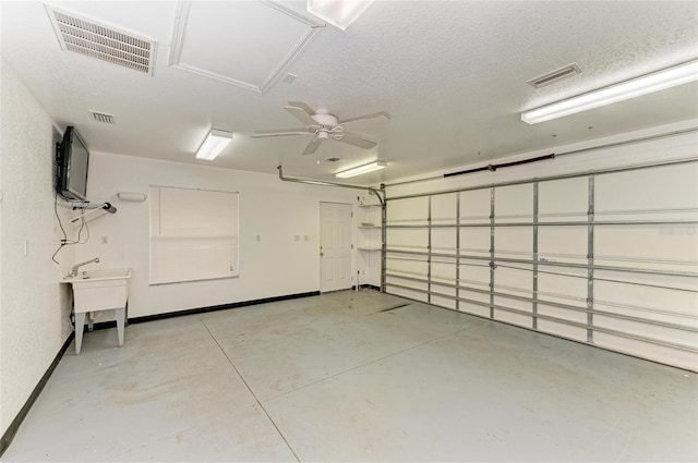 garage featuring baseboards and visible vents
