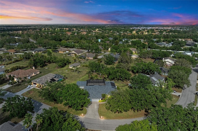 aerial view at dusk featuring a residential view