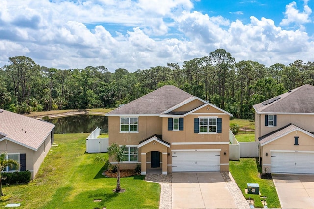 traditional home with stucco siding, concrete driveway, a forest view, and an attached garage