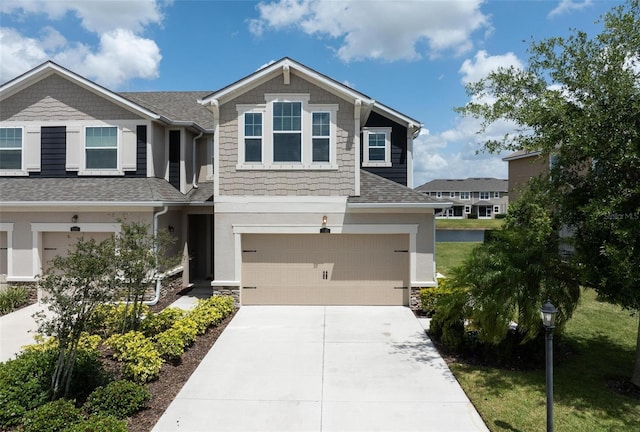 5543 Pleasantview Ct, Bradenton, FL 34211 - craftsman house featuring a garage, concrete driveway, roof with shingles, and stone siding