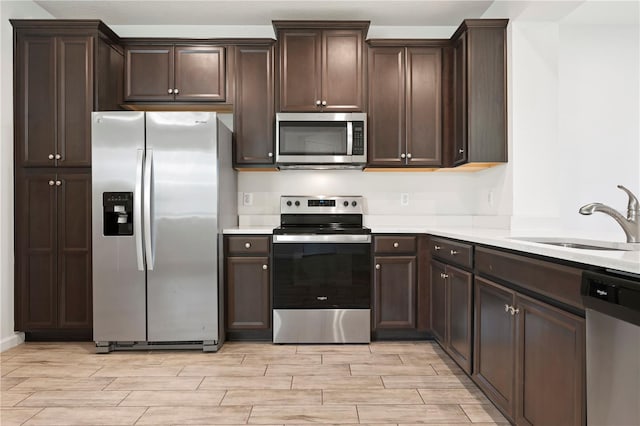 5543 Pleasantview Ct, Bradenton, FL 34211 - kitchen with a sink, appliances with stainless steel finishes, light wood-style floors, and light countertops