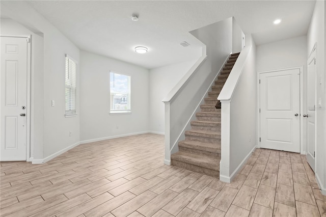 5543 Pleasantview Ct, Bradenton, FL 34211 - entrance foyer featuring visible vents, stairs, baseboards, light wood-style floors, and recessed lighting