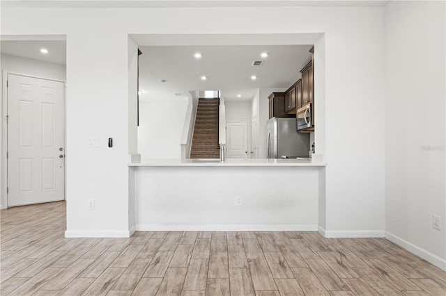 5543 Pleasantview Ct, Bradenton, FL 34211 - unfurnished living room with recessed lighting, baseboards, light wood-style flooring, and stairway