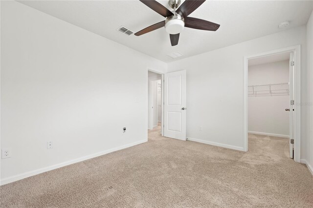 5543 Pleasantview Ct, Bradenton, FL 34211 - unfurnished bedroom with baseboards, a walk in closet, light carpet, and visible vents