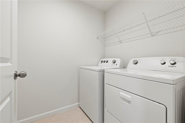 5543 Pleasantview Ct, Bradenton, FL 34211 - clothes washing area featuring separate washer and dryer, laundry area, light tile patterned floors, and baseboards