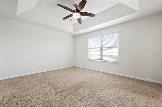 5543 Pleasantview Ct, Bradenton, FL 34211 - unfurnished room with baseboards, a ceiling fan, a raised ceiling, and light carpet