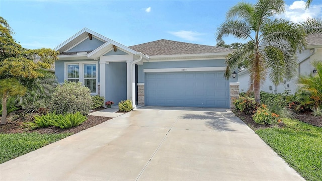 8110 Trimbelle Ter, Parrish, FL 34219 - view of front of property with stucco siding, a garage, and driveway