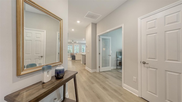 8110 Trimbelle Ter, Parrish, FL 34219 - hallway with light wood-style floors and recessed lighting