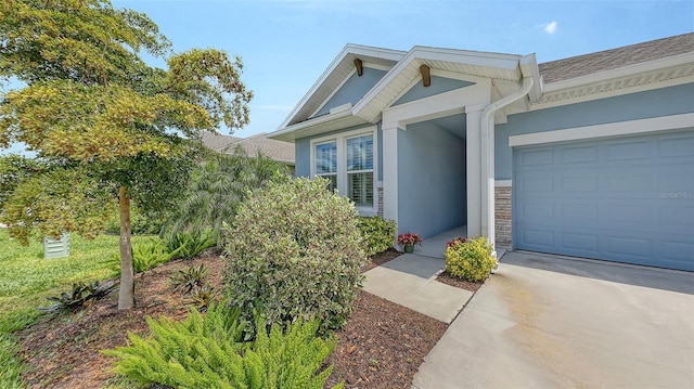 8110 Trimbelle Ter, Parrish, FL 34219 - view of front of home featuring concrete driveway, stucco siding, a garage, and stone siding
