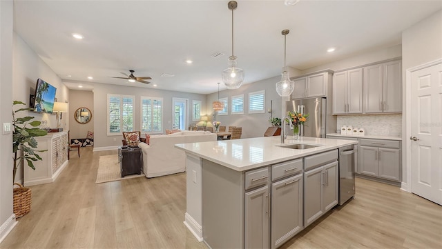 8110 Trimbelle Ter, Parrish, FL 34219 - kitchen with gray cabinets, stainless steel appliances, light wood-type flooring, open floor plan, and recessed lighting