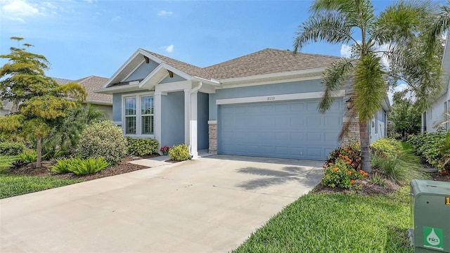 8110 Trimbelle Ter, Parrish, FL 34219 - view of front of home featuring stucco siding, an attached garage, driveway, stone siding, and roof with shingles