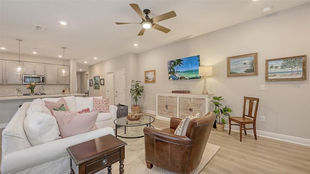 8110 Trimbelle Ter, Parrish, FL 34219 - living area featuring light wood finished floors, recessed lighting, and ceiling fan