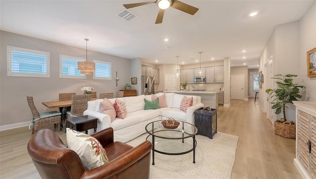 8110 Trimbelle Ter, Parrish, FL 34219 - living room with a ceiling fan, light wood-style floors, and recessed lighting
