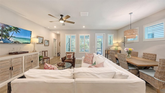 8110 Trimbelle Ter, Parrish, FL 34219 - living area featuring light wood-style floors, healthy amount of natural light, a ceiling fan, and recessed lighting