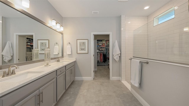 8110 Trimbelle Ter, Parrish, FL 34219 - full bathroom with double vanity, a spacious closet, and a walk in shower