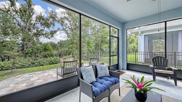 8110 Trimbelle Ter, Parrish, FL 34219 - sunroom featuring an outdoor living space, view of scattered trees, and ceiling fan