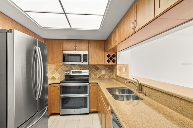 825 S Osprey Ave Unit 302, Sarasota, FL 34236 - kitchen featuring tasteful backsplash, light stone counters, a sink, and stainless steel appliances