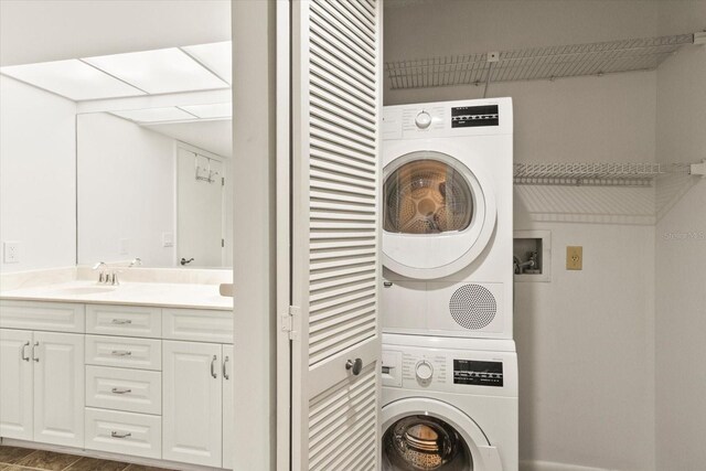 825 S Osprey Ave Unit 302, Sarasota, FL 34236 - clothes washing area with stacked washer and clothes dryer, laundry area, and a sink
