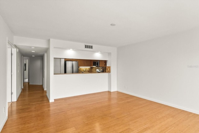 825 S Osprey Ave Unit 302, Sarasota, FL 34236 - unfurnished living room with baseboards, light wood-style floors, and visible vents