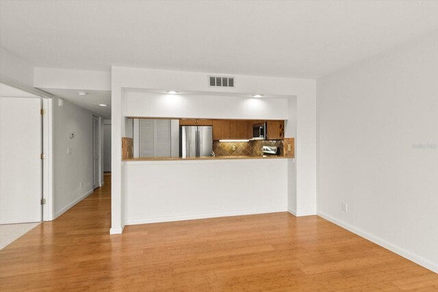 825 S Osprey Ave Unit 302, Sarasota, FL 34236 - unfurnished living room featuring wood finished floors, baseboards, and visible vents