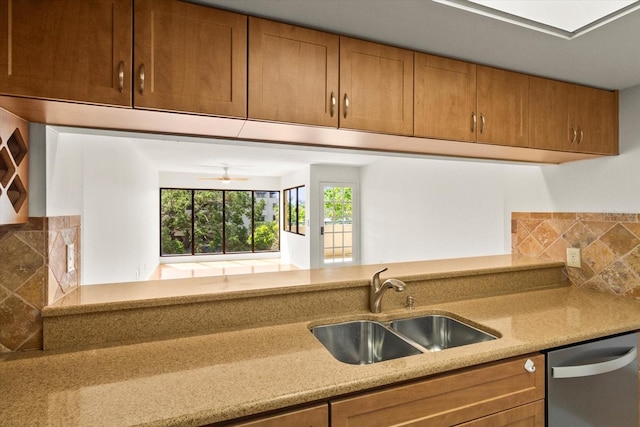 825 S Osprey Ave Unit 302, Sarasota, FL 34236 - kitchen featuring dishwasher, a sink, tasteful backsplash, and brown cabinetry