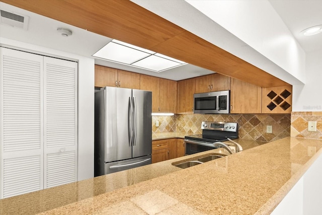 825 S Osprey Ave Unit 302, Sarasota, FL 34236 - kitchen with tasteful backsplash, a sink, visible vents, appliances with stainless steel finishes, and brown cabinets