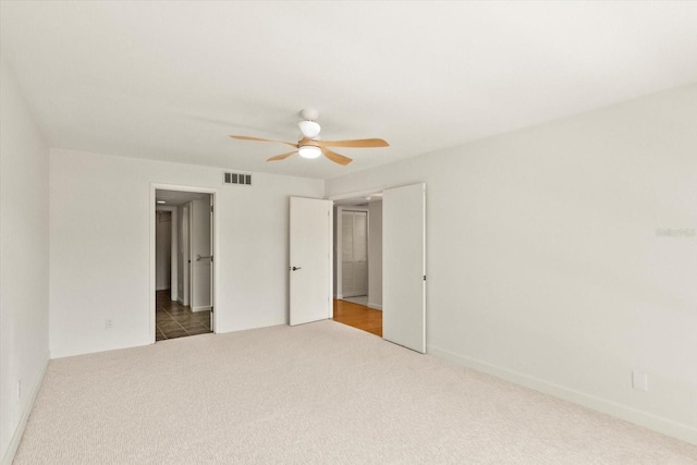 825 S Osprey Ave Unit 302, Sarasota, FL 34236 - unfurnished bedroom with baseboards, carpet flooring, ceiling fan, and visible vents