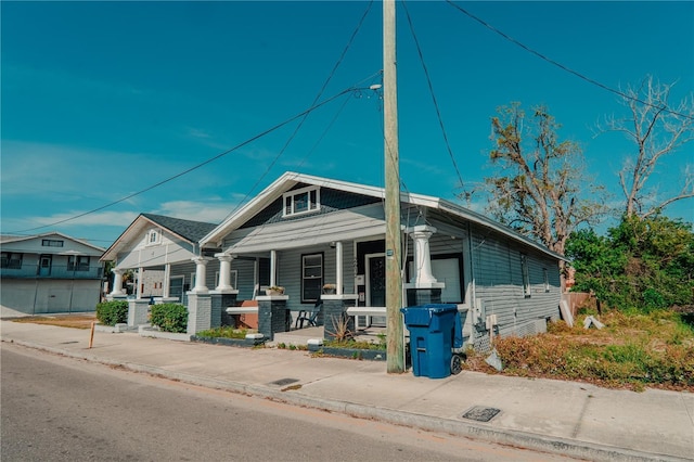 view of front of property featuring a porch and cooling unit