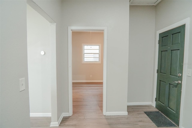 entrance foyer featuring baseboards and light wood finished floors
