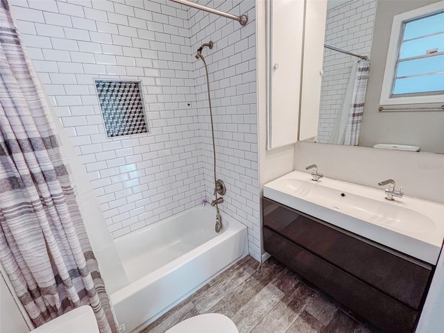 bathroom with wood finished floors, shower / bath combination with curtain, vanity, and toilet
